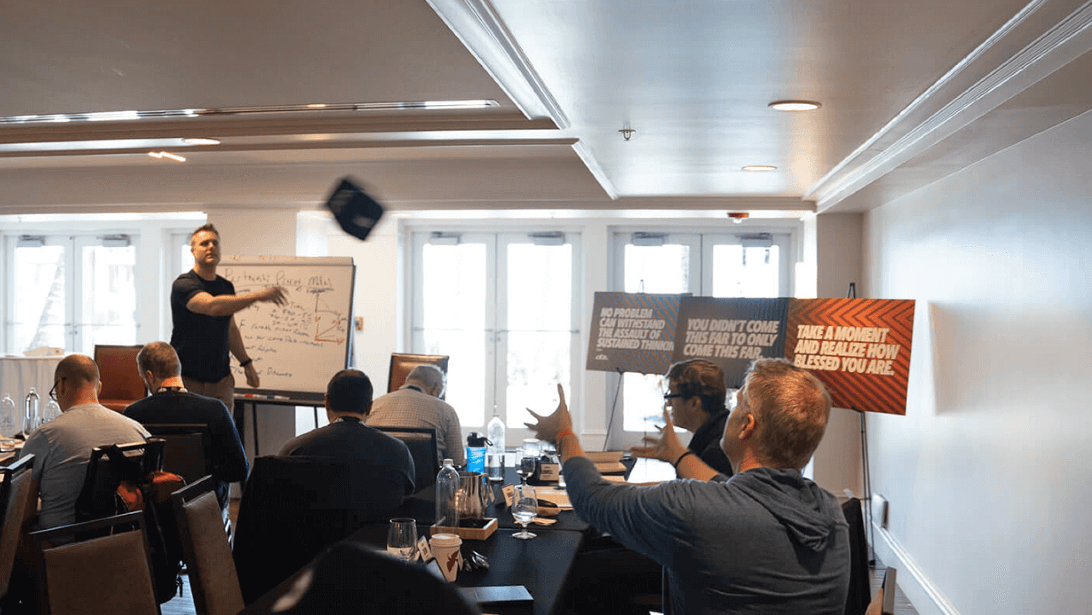 A presenter tosses a microphone  to a conference attendee