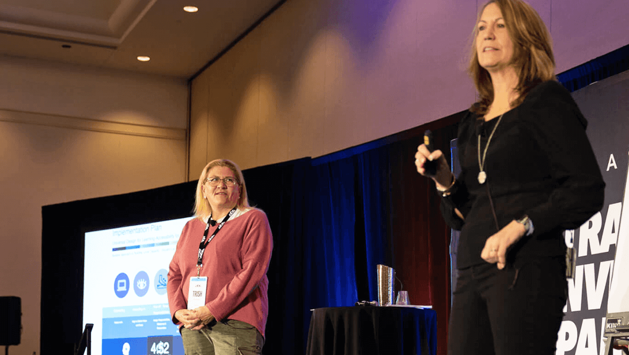 Two women present on a stage