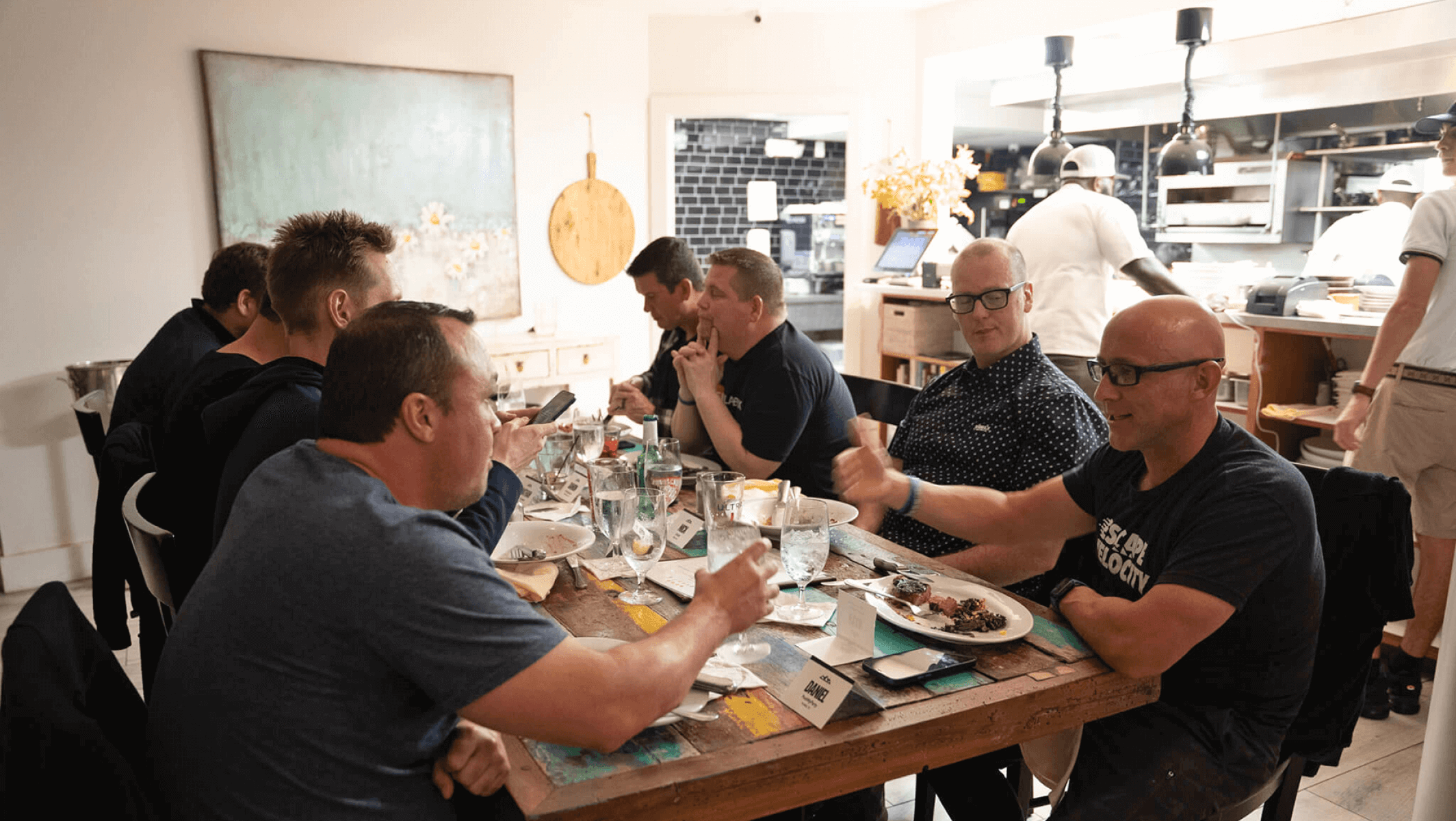 A group of attendees eat together around a table