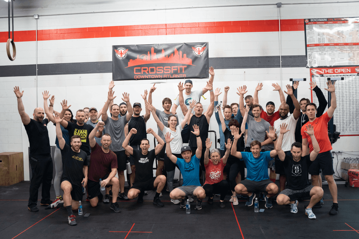 A group of founders pose in a group with arms raised