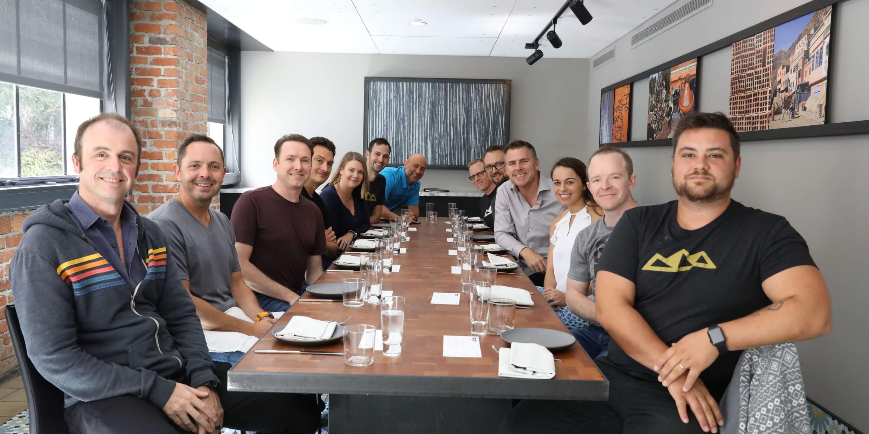 A SaaS Academy group at work around a table
