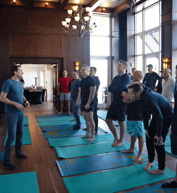 Boardroom Program event attendees standing on yoga mats